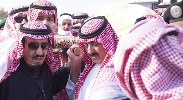 Handout photo of Saudi King Salman carrying the body of the late Saudi King Abdullah during his funeral in Riyadh