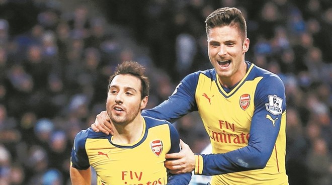 Arsenal's Santi Cazorla celebrates his goal from a penalty with teammate during their English Premier League soccer match against Manchester City in Manchester