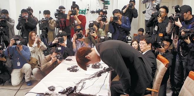 South Korea's Olympic swimming champion Park Tae-hwan bows during a news conference at a hotel in Seoul