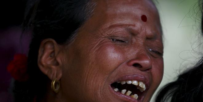A woman mourns the death of a family member a day after an earthquake in Bhaktapur