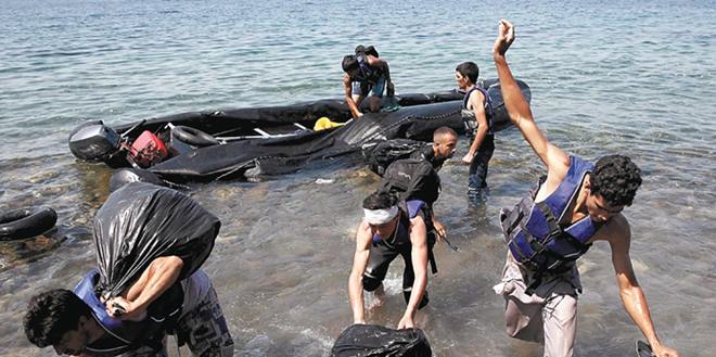 A dinghy with Afghan immigrants arrives on the coast of the Greek island of Lesbos after crossing from Turkey to Greece