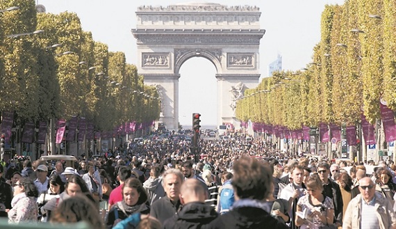 People walk on the Champs-Elysees as central Paris goes car-free on Sunday