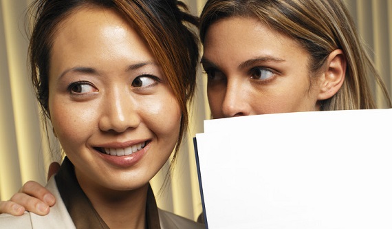 Businessman Looking Suspiciously Over His Shoulder