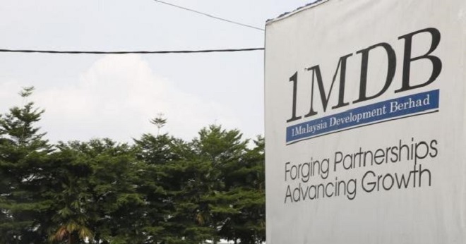 Traffic passes a 1Malaysia Development Berhad (1MDB) billboard at the Tun Razak Exchange development in Kuala Lumpur, Malaysia