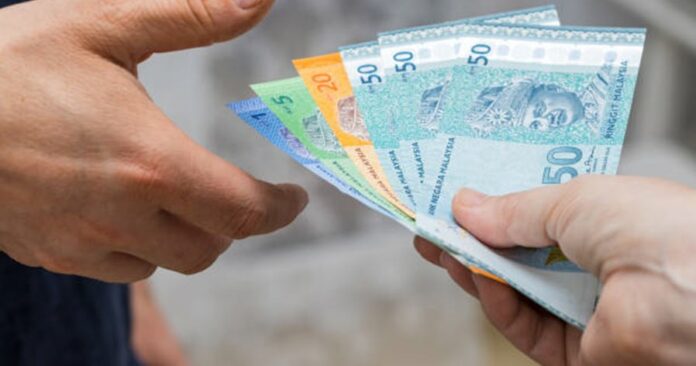 a-file-of-malaysian-money-ringgit-given-to-another-person-from-hand-to-hand