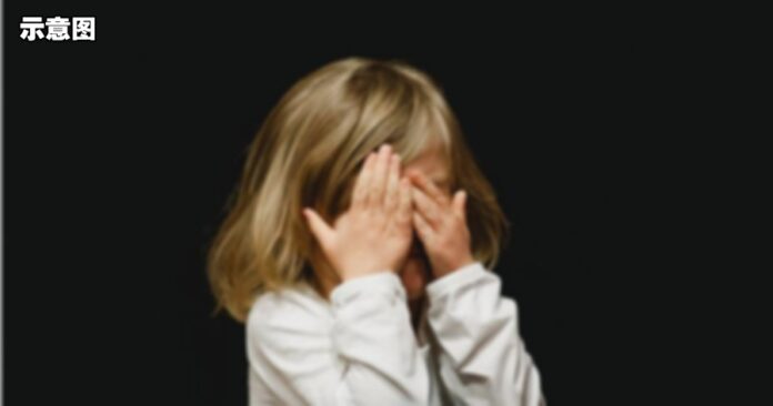 child covering face