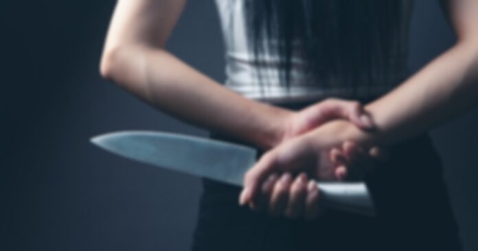 holding knife woman