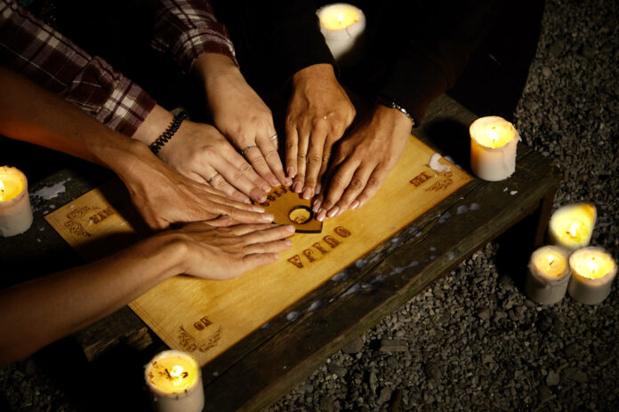 Communicating,With,Ghosts,Through,Spiritual,Board,Under,Candle,Lights