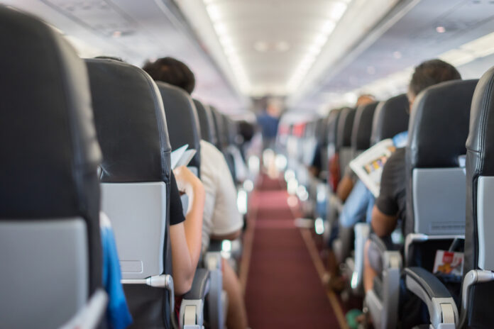 Passenger,Seat,,Interior,Of,Airplane,With,Passengers,Sitting,On,Seats