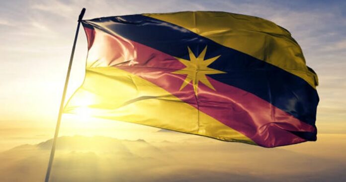 sarawak-state-of-malaysia-flag-textile-cloth-fabric-waving-on-the-top-sunrise-mist-fog