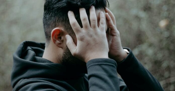 free-photo-of-a-man-holding-his-head
