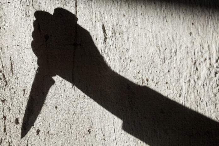 Shadow,Of,The,Hand,Holding,A,Big,Sharp,Knife.,Murderer,